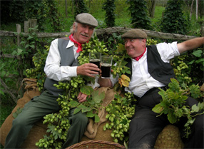 Hop n' Harvest Festival, two men in traditional clothing surrounded by hops